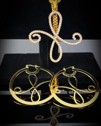 Gold Bonafide Glam Luxe jewelry set with unique confidence pendant and hoop earrings on a black background