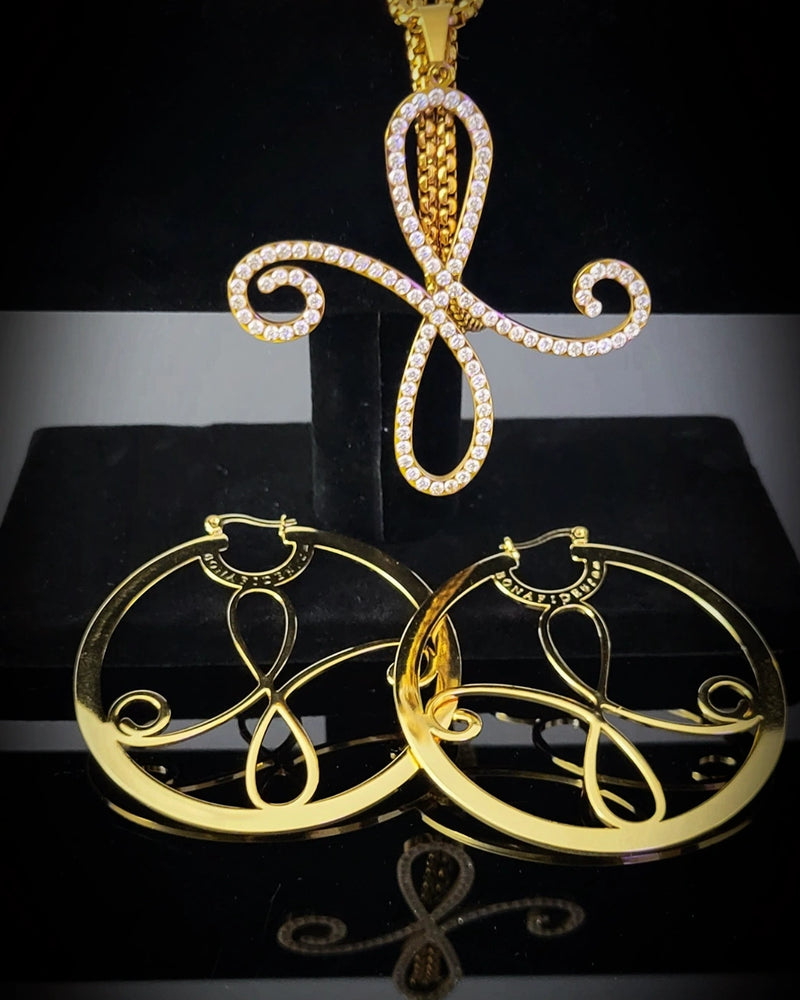 Gold Bonafide Glam Luxe jewelry set with unique confidence pendant and hoop earrings on a black background
